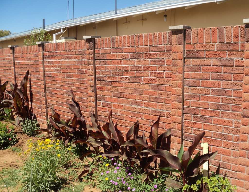A newly installed face brick style precast concrete wall for a residential home.