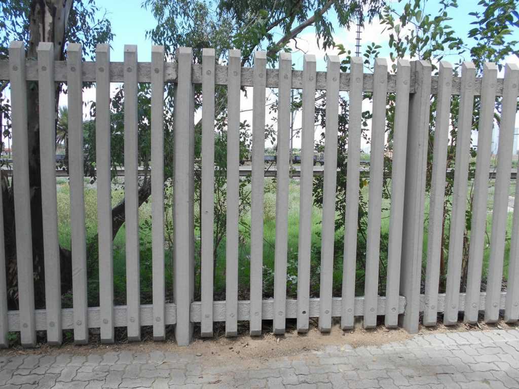 Heavy-duty concrete palisade fencing providing high security for a property.